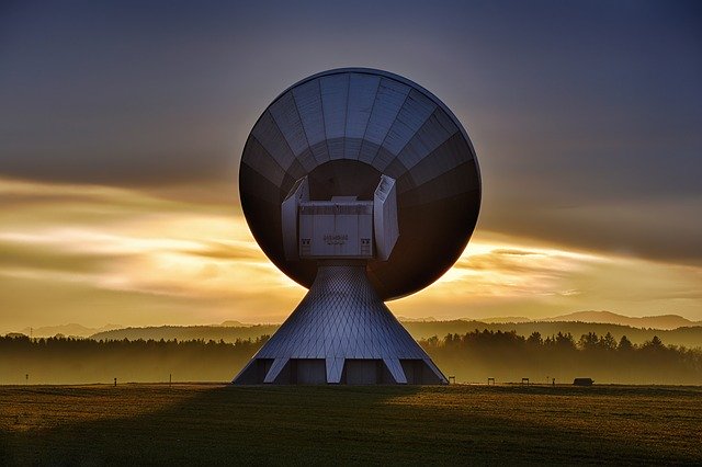 satellite dish and the sun setting